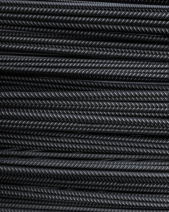 Close-up view of neatly stacked metal rebars showcasing detailed texture and industrial feel.